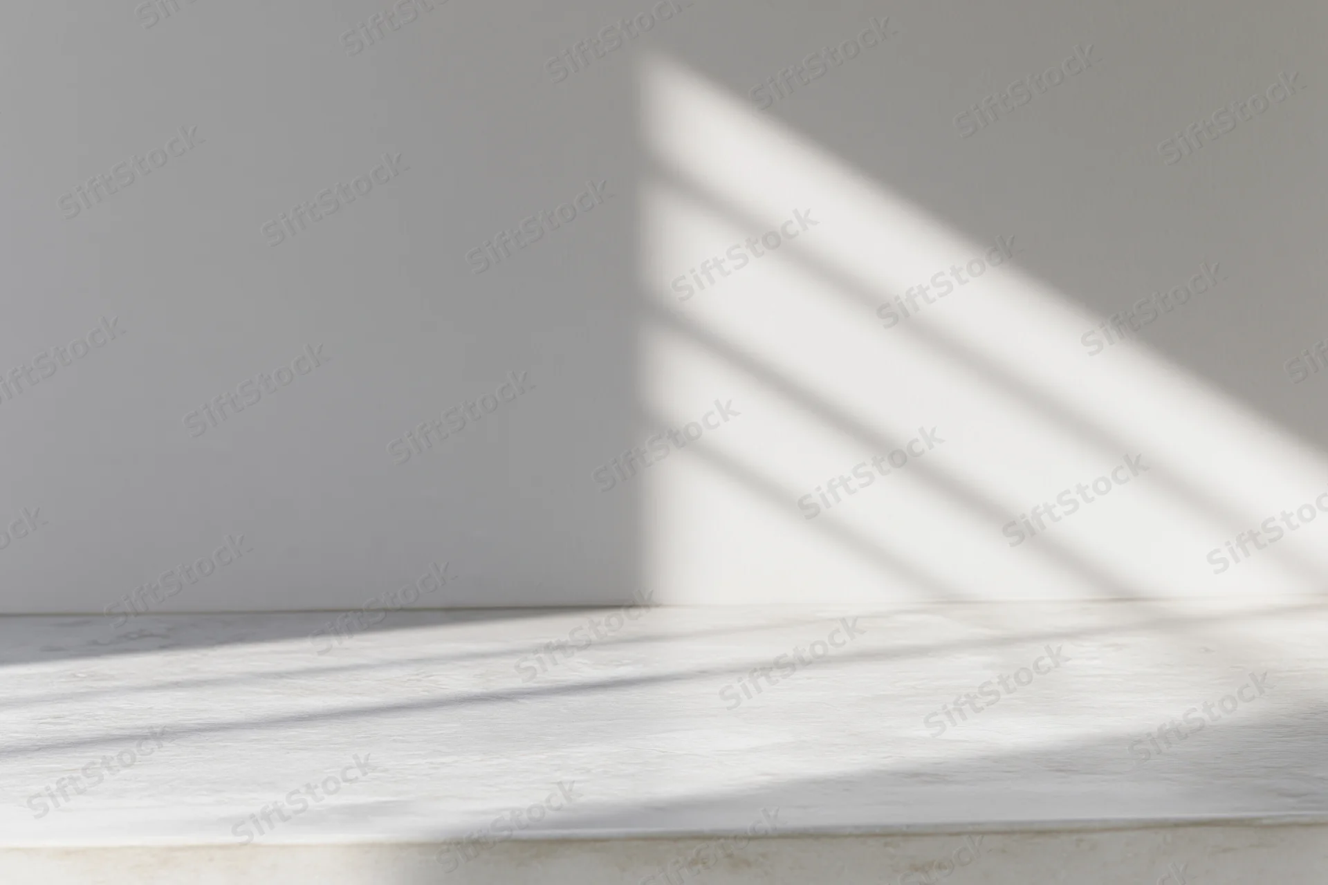 Polished concrete tabletop with diagonal light and shadow patterns from a window, in a minimalist interior