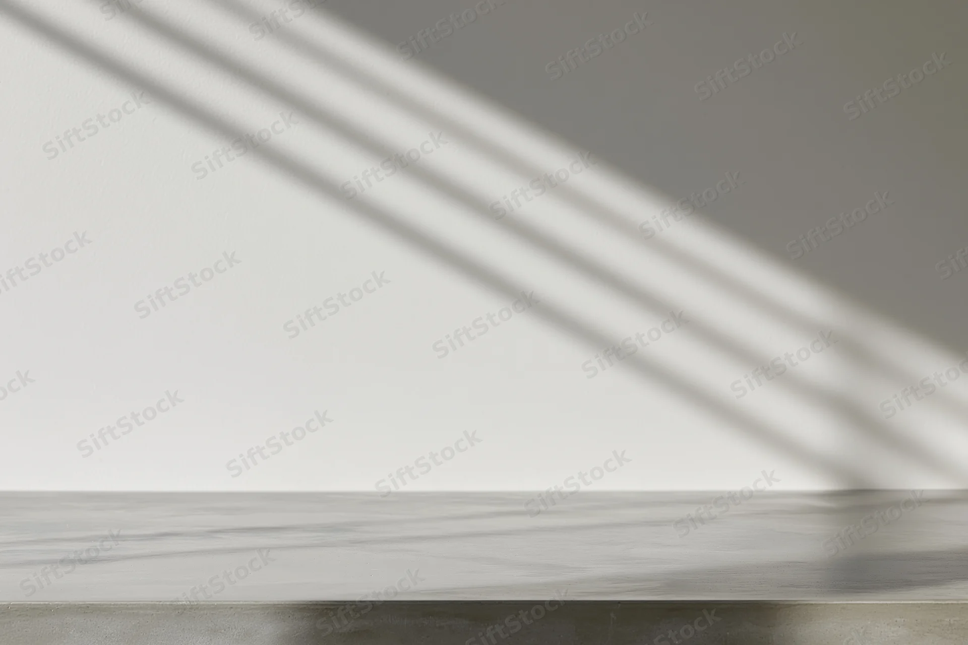 Polished concrete tabletop surface with diagonal light shadows from window blinds in minimalist interior
