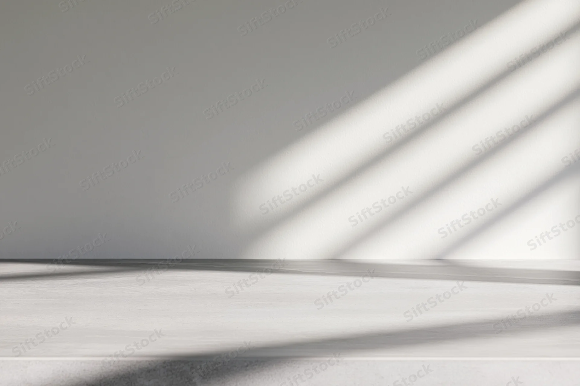 Polished concrete table surface with diagonal light shadows in a minimalist interior