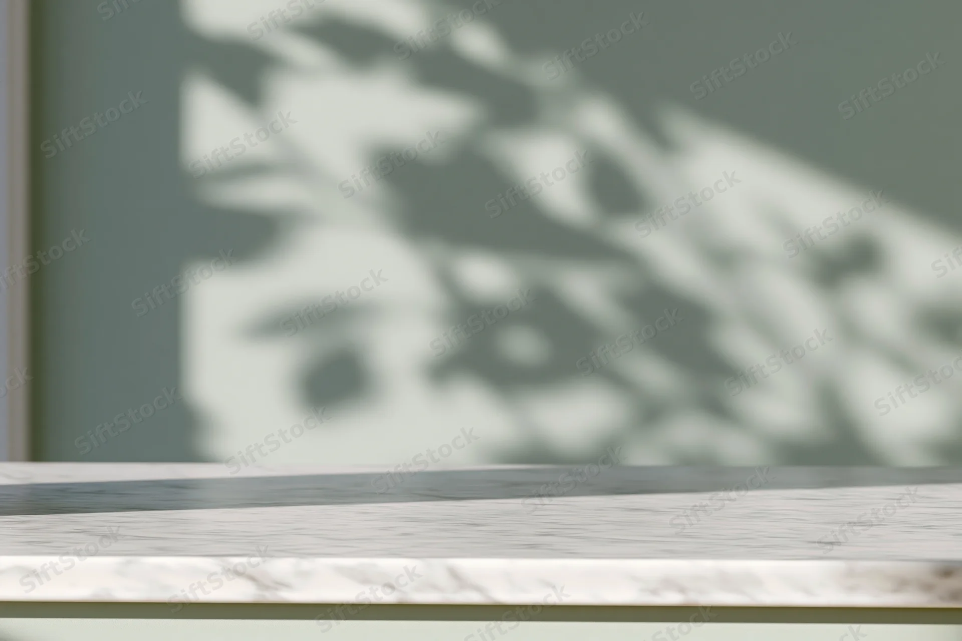 White marble surface with leaf shadows on a green wall in a modern interior