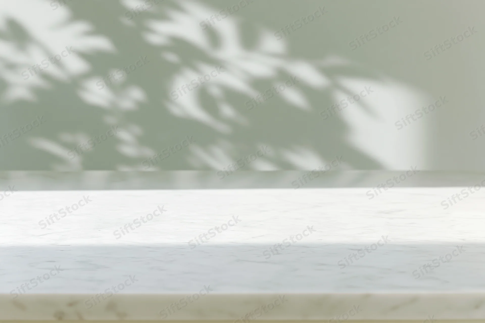 White marble surface with soft leaf shadow projection in interior setting