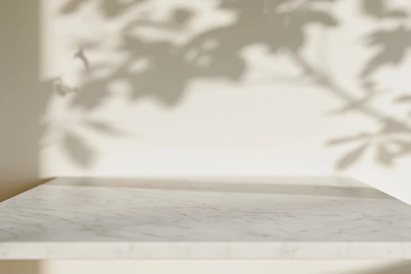 White marble tabletop with leaf shadows in a bright interior