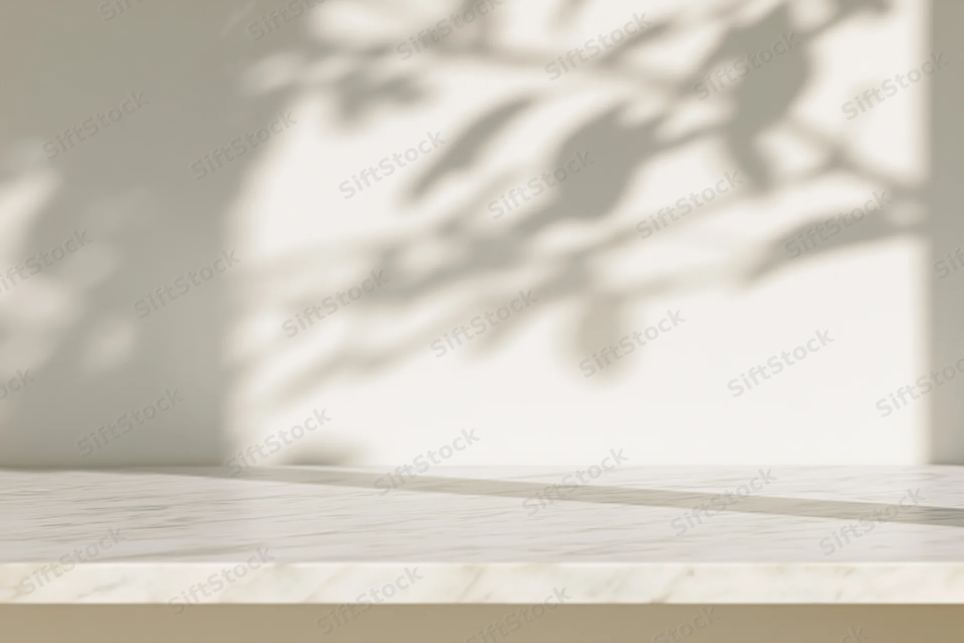 Smooth white marble tabletop in a bright room with plant shadows on the wall