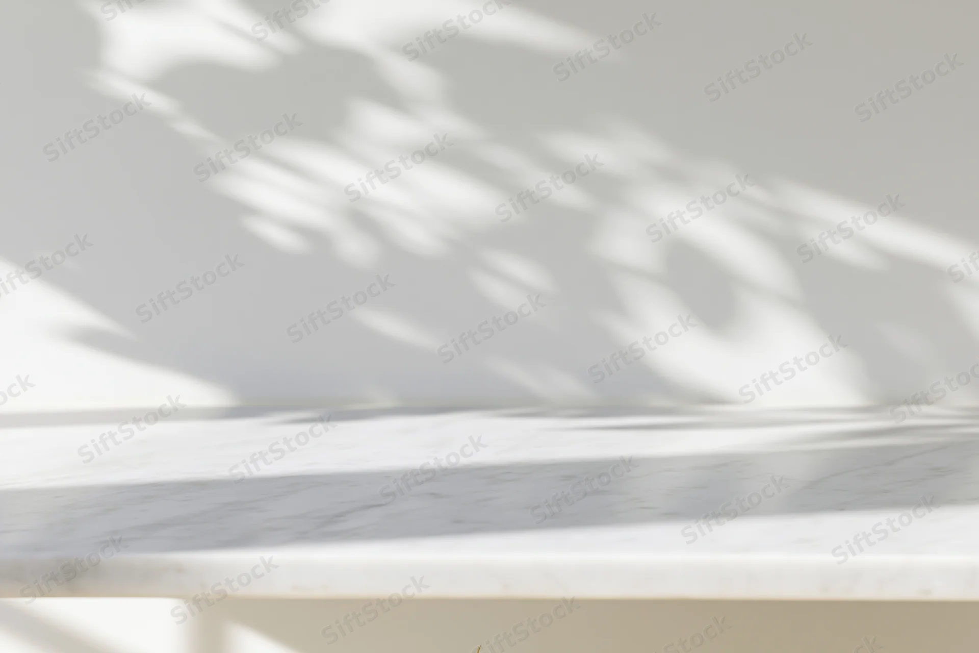 White marble tabletop with dappled sunlight shadows in a minimalist interior