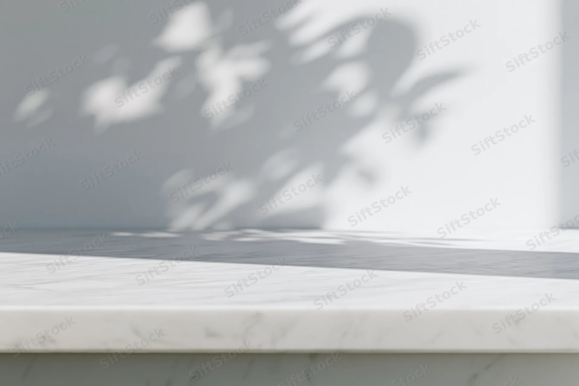 White marble tabletop with leaf shadows in a bright minimalist interior