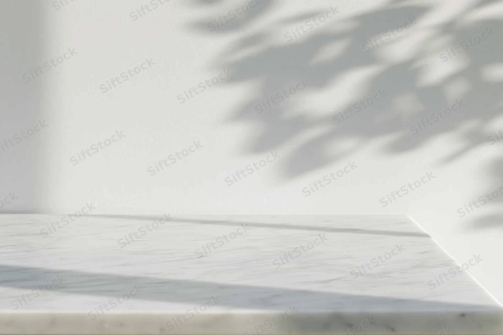 White marble tabletop surface with leaf shadows in bright daylight interior