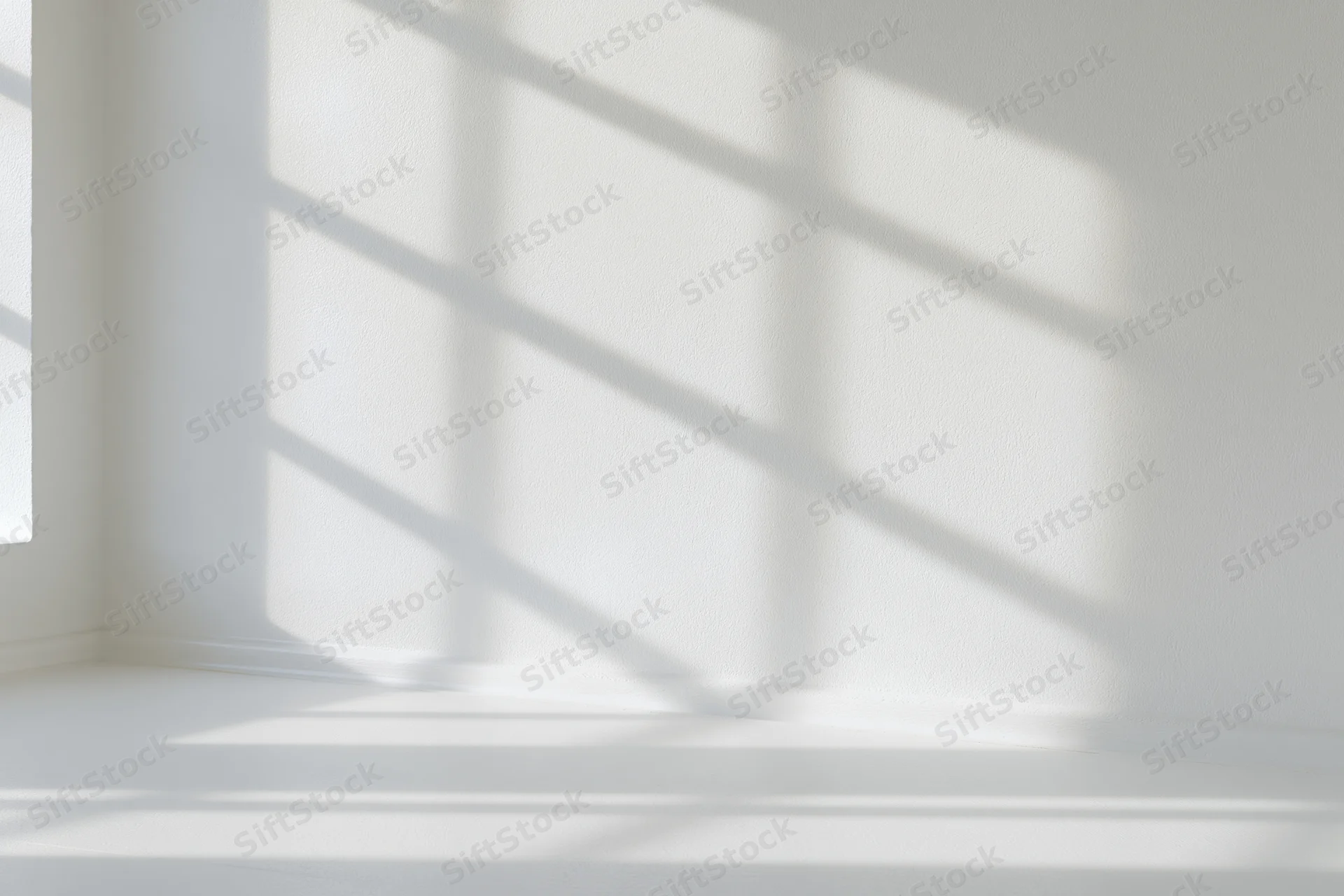 Empty white room interior with window shadow patterns on walls and floor