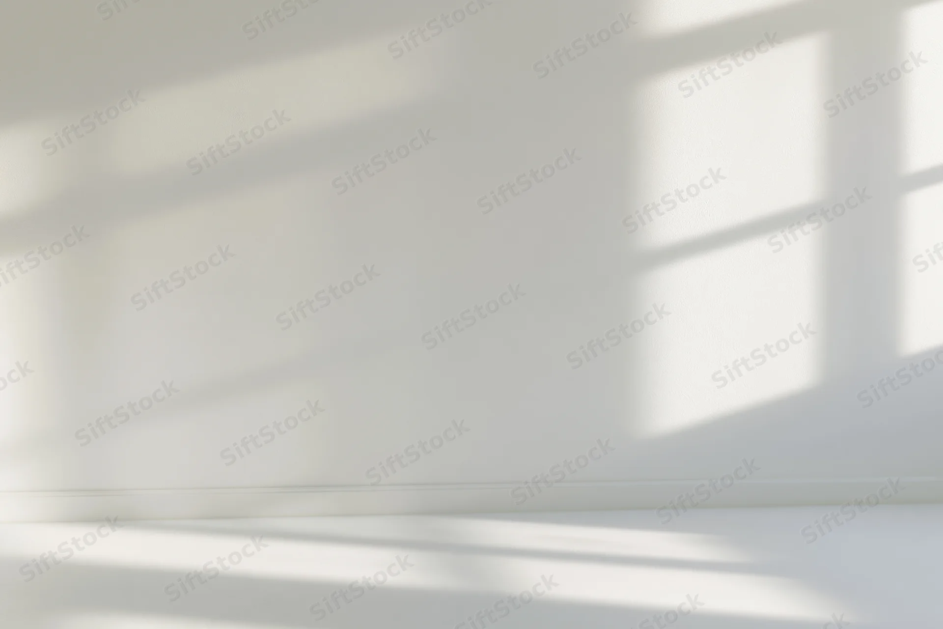 Empty white room interior with soft window shadow patterns on walls and floor