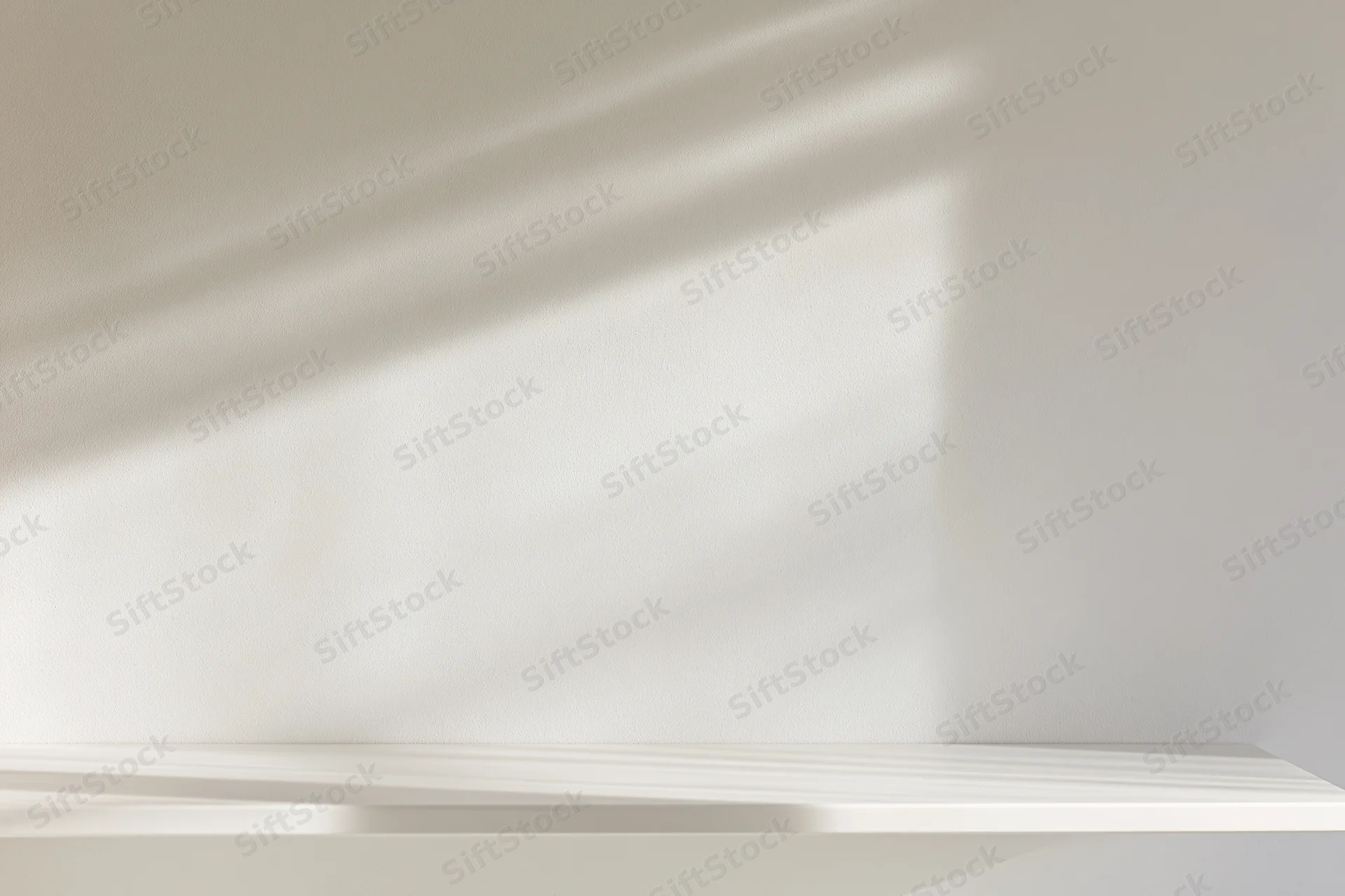 White shelf mounted on a smooth wall with soft shadows from natural light