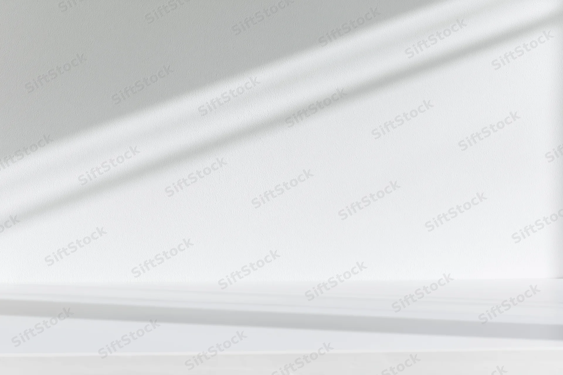 White surface against smooth white wall in minimalist interior space