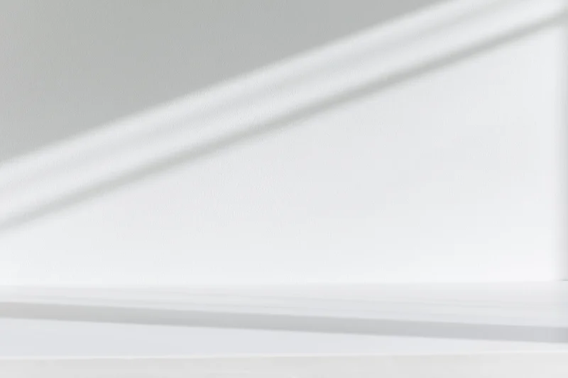 White surface against smooth white wall in minimalist interior space