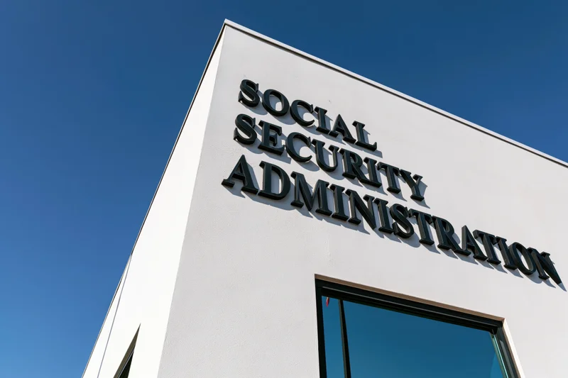 Corner of social security administration building with bold sign against blue sky