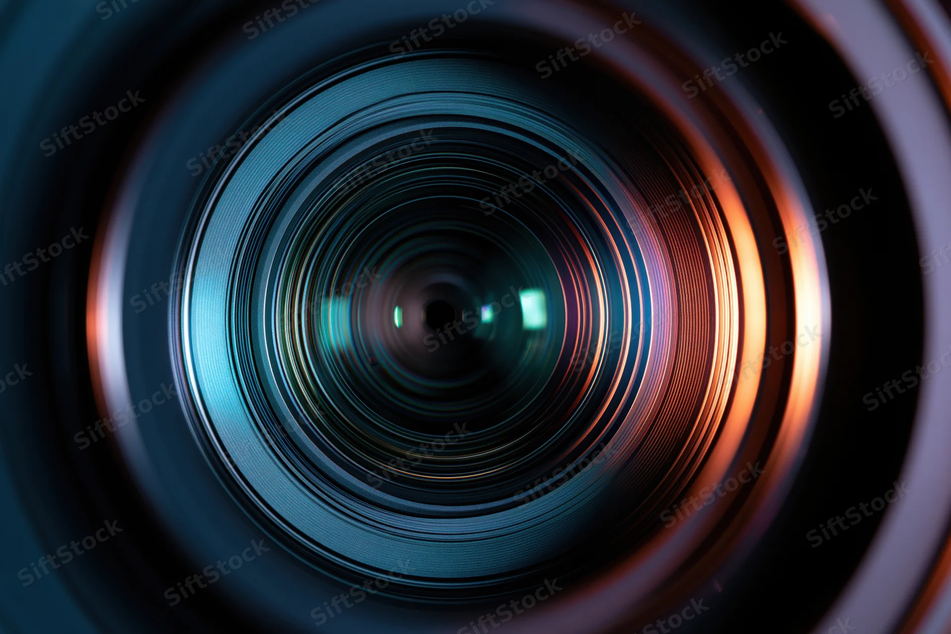 Extreme close-up view into a camera lens showing concentric glass rings and light reflections
