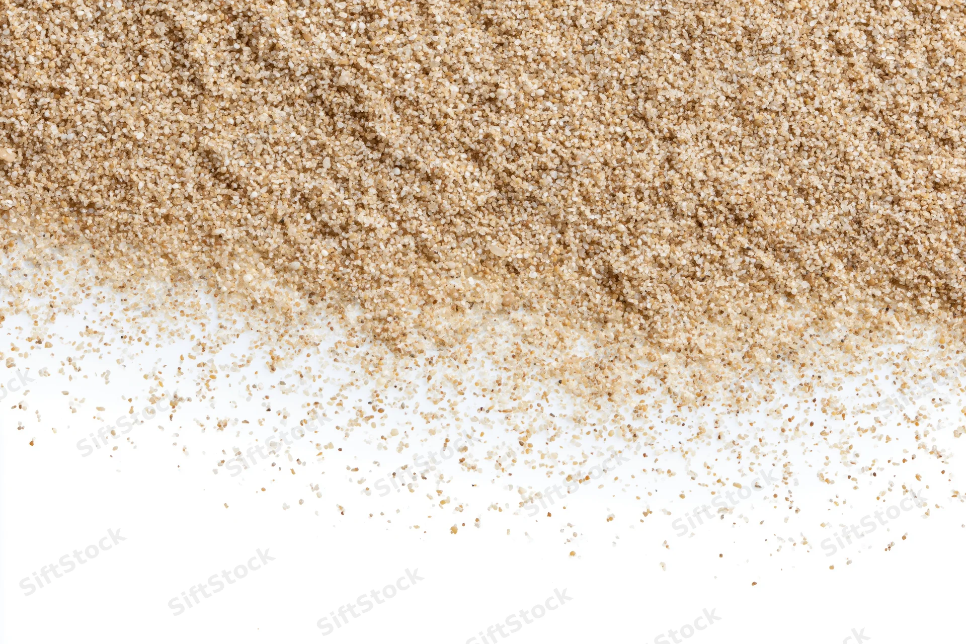 Fine beach sand scattered across a clean white surface forming a textured pile with copyspace below