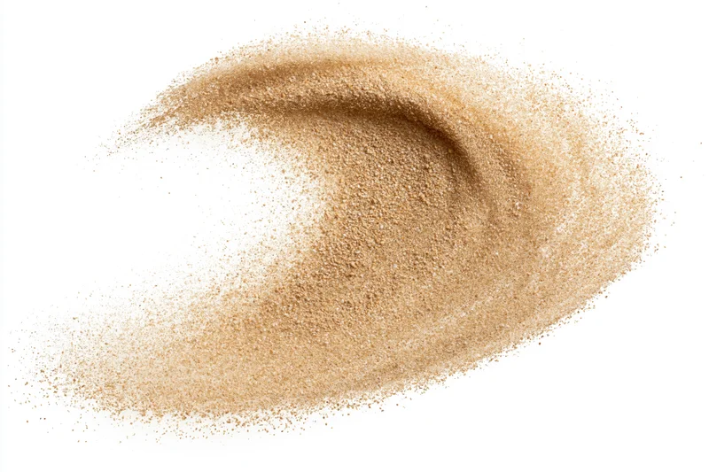 Fine desert sand mid-explosion frozen in motion against white background