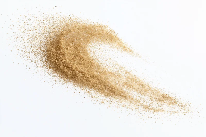 Fine desert sand mid-explosion frozen in motion against white background