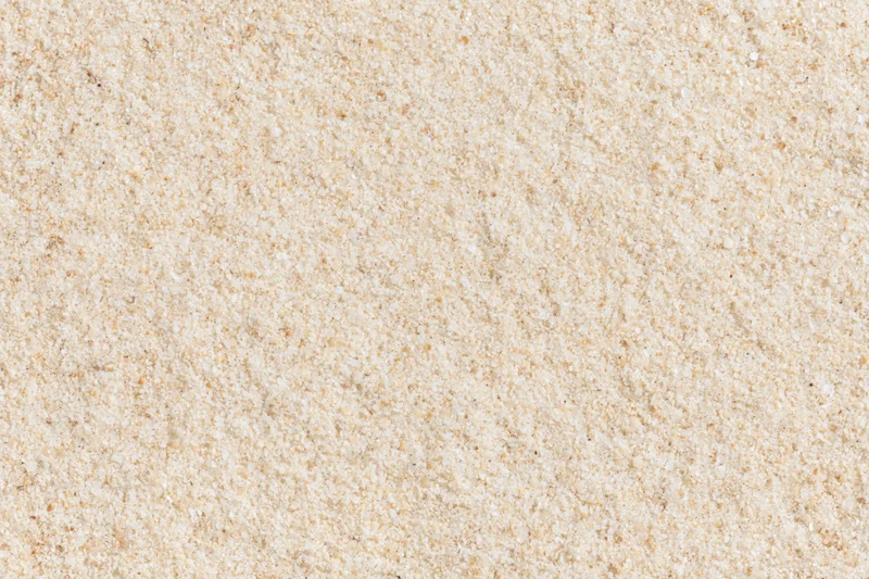 Closeup of fine dry beach sand filling the frame as a textured surface