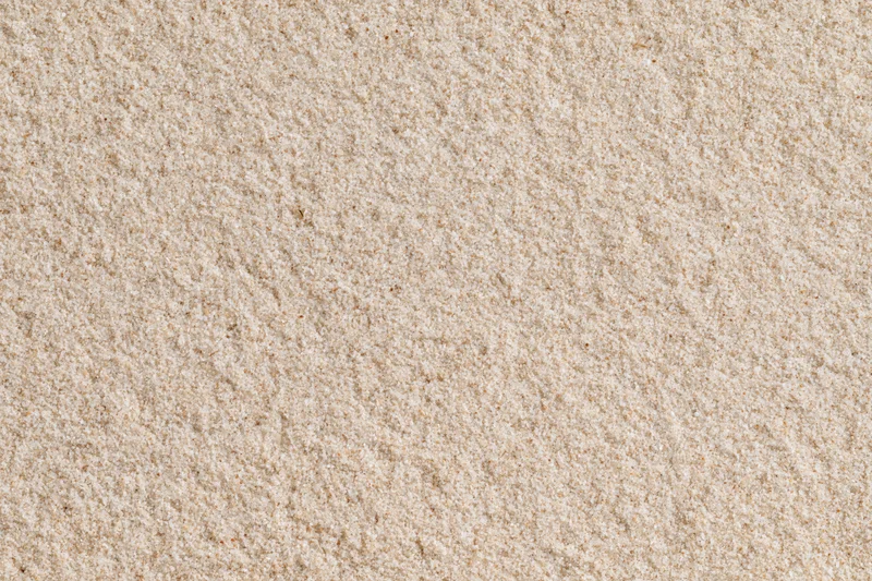Fine dry beach sand filling the frame as a flat textured surface