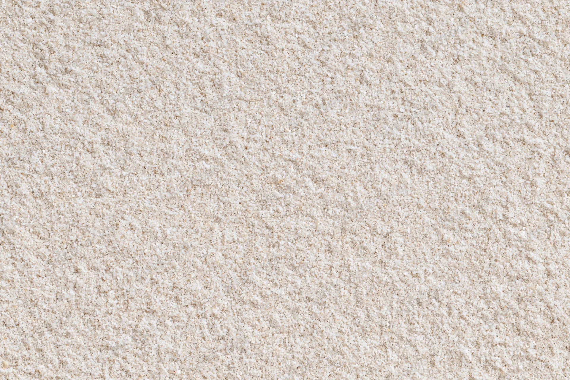 Closeup of fine dry beach sand surface viewed from directly above in flat lay style