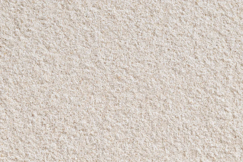 Closeup of fine dry beach sand surface viewed from directly above in flat lay style