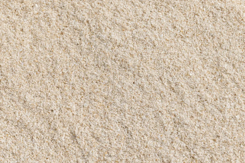Overhead view of dry beach sand surface filling the frame