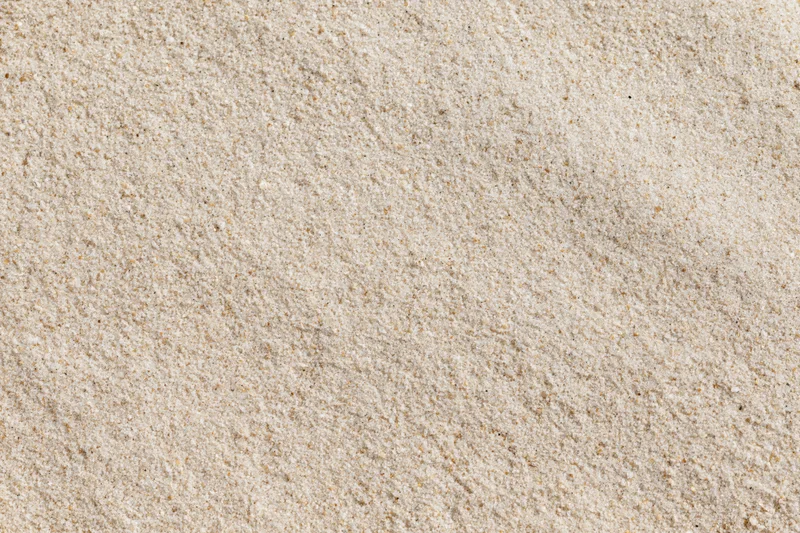 Overhead view of dry beach sand surface filling the frame