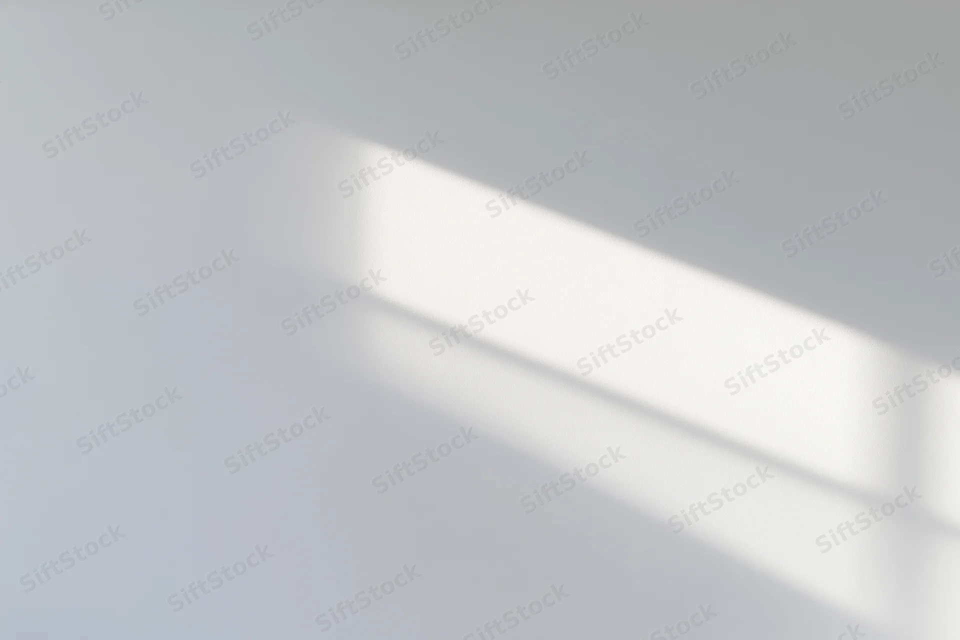 Bright rectangular patch of afternoon sunlight on a smooth white surface
