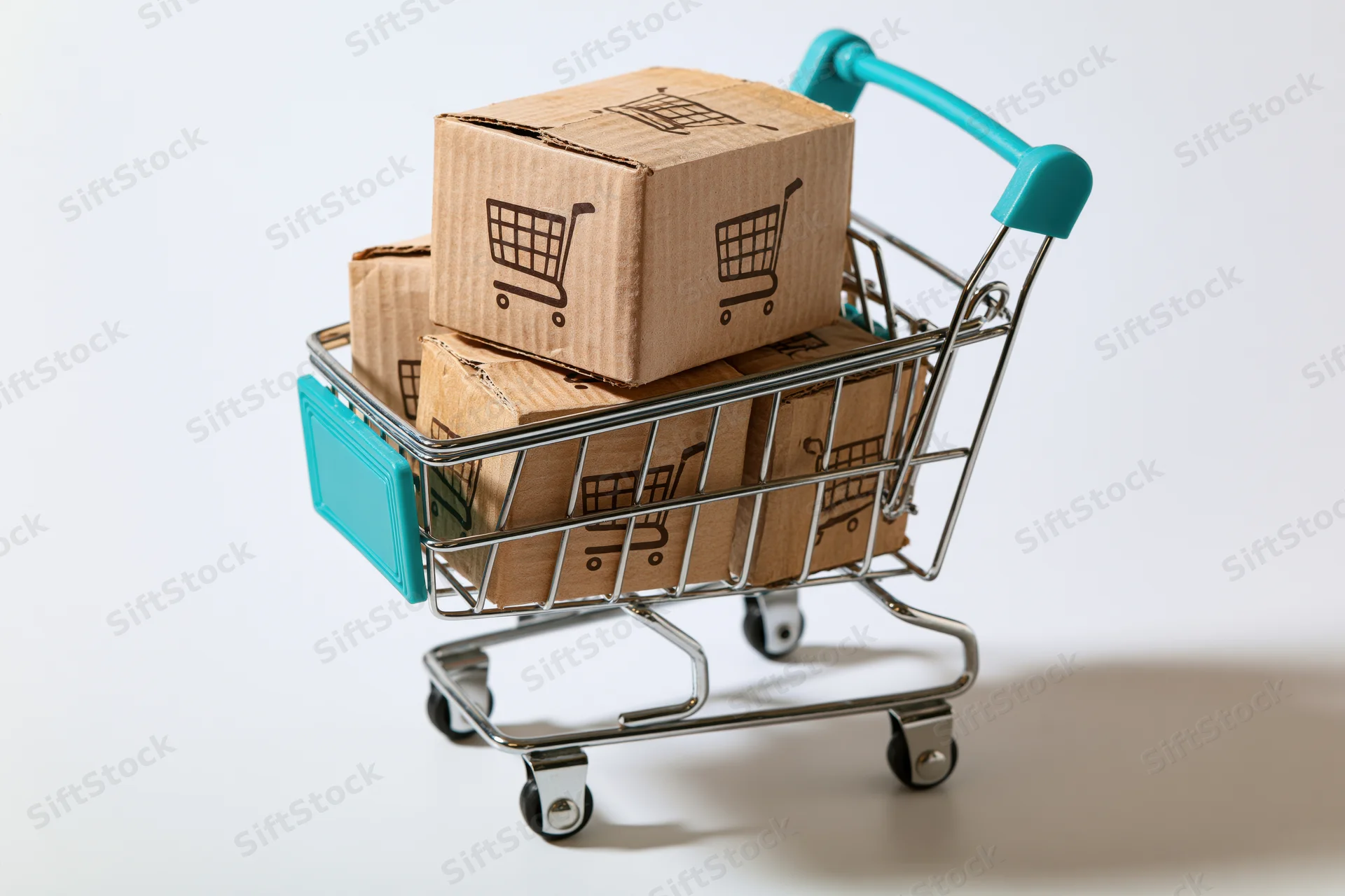 Small metal shopping cart filled with cardboard boxes printed with shopping cart symbols on white background