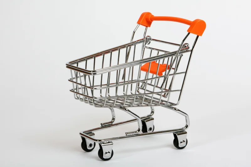 Miniature shopping cart toy empty on white background