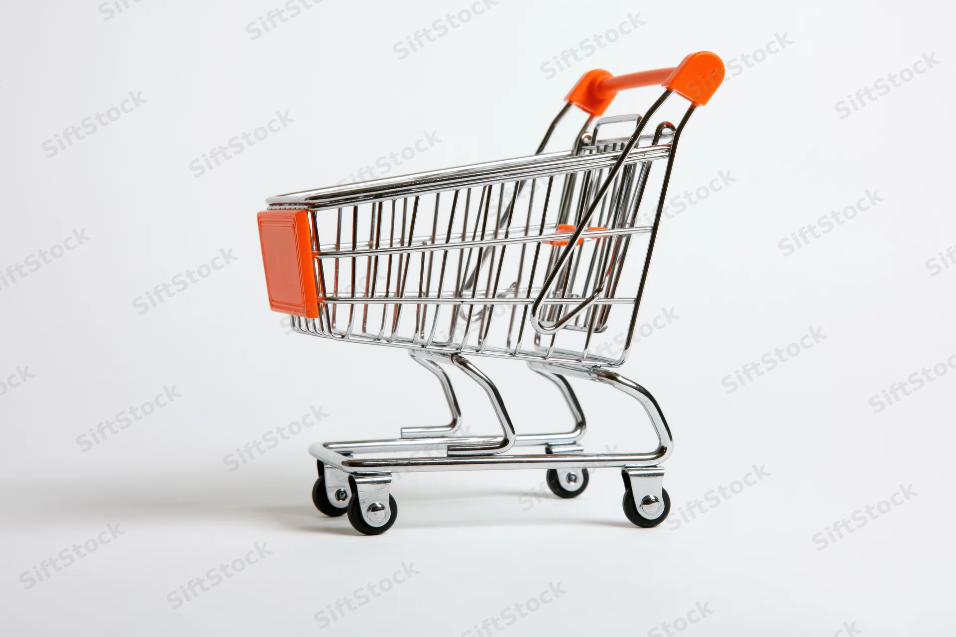 Miniature shopping cart toy empty on white background