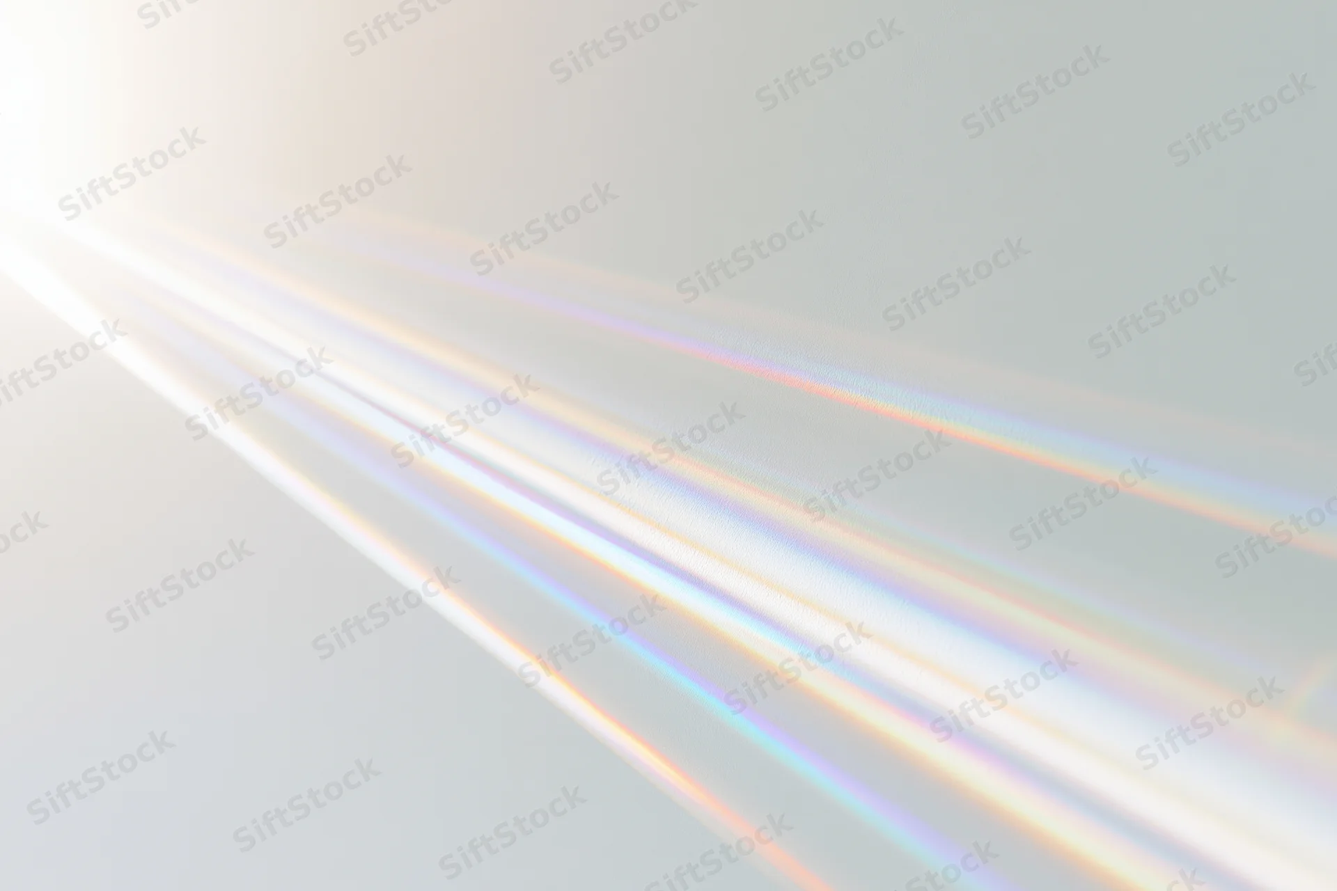 Sunlight refracting through a prism casting colorful beams across a bright surface
