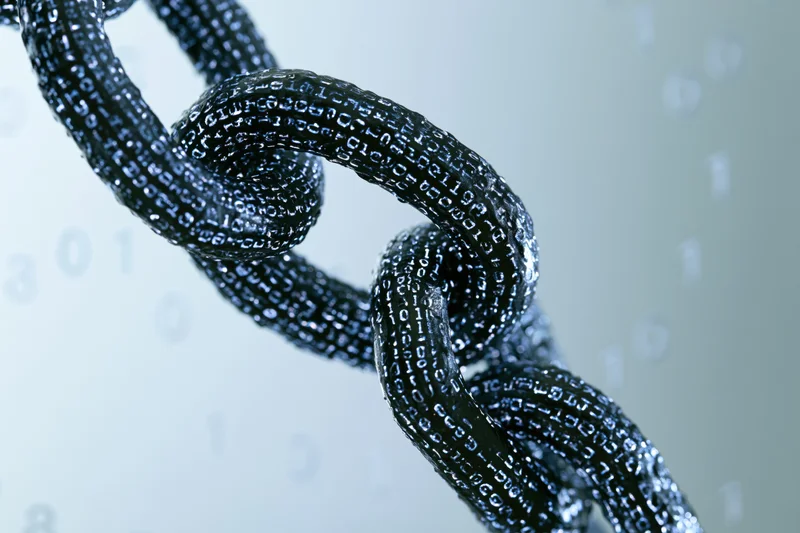 Closeup of interlocked chain links covered in glowing binary code against a light background