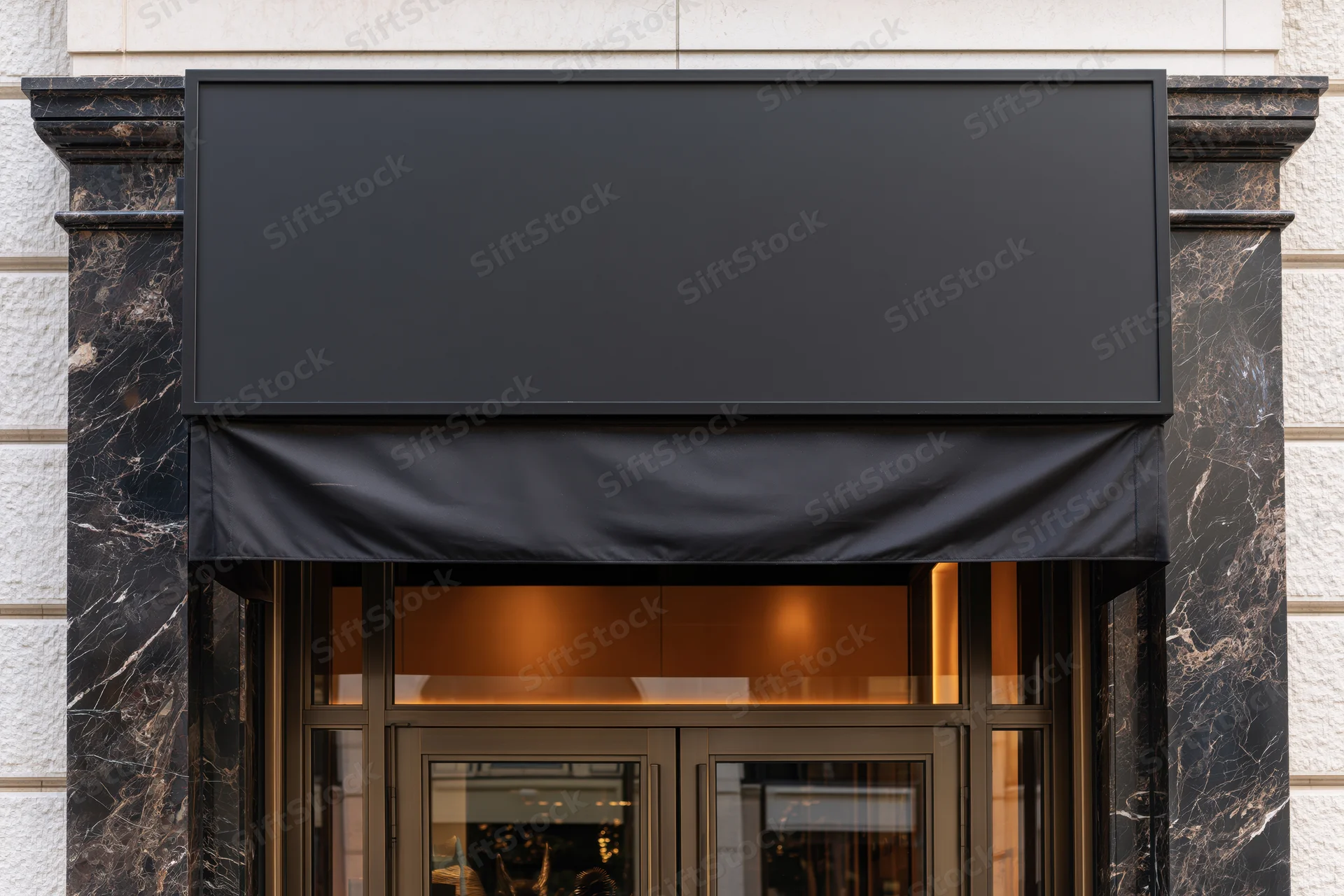 Upscale retail storefront entrance with blank black awning and marble facade