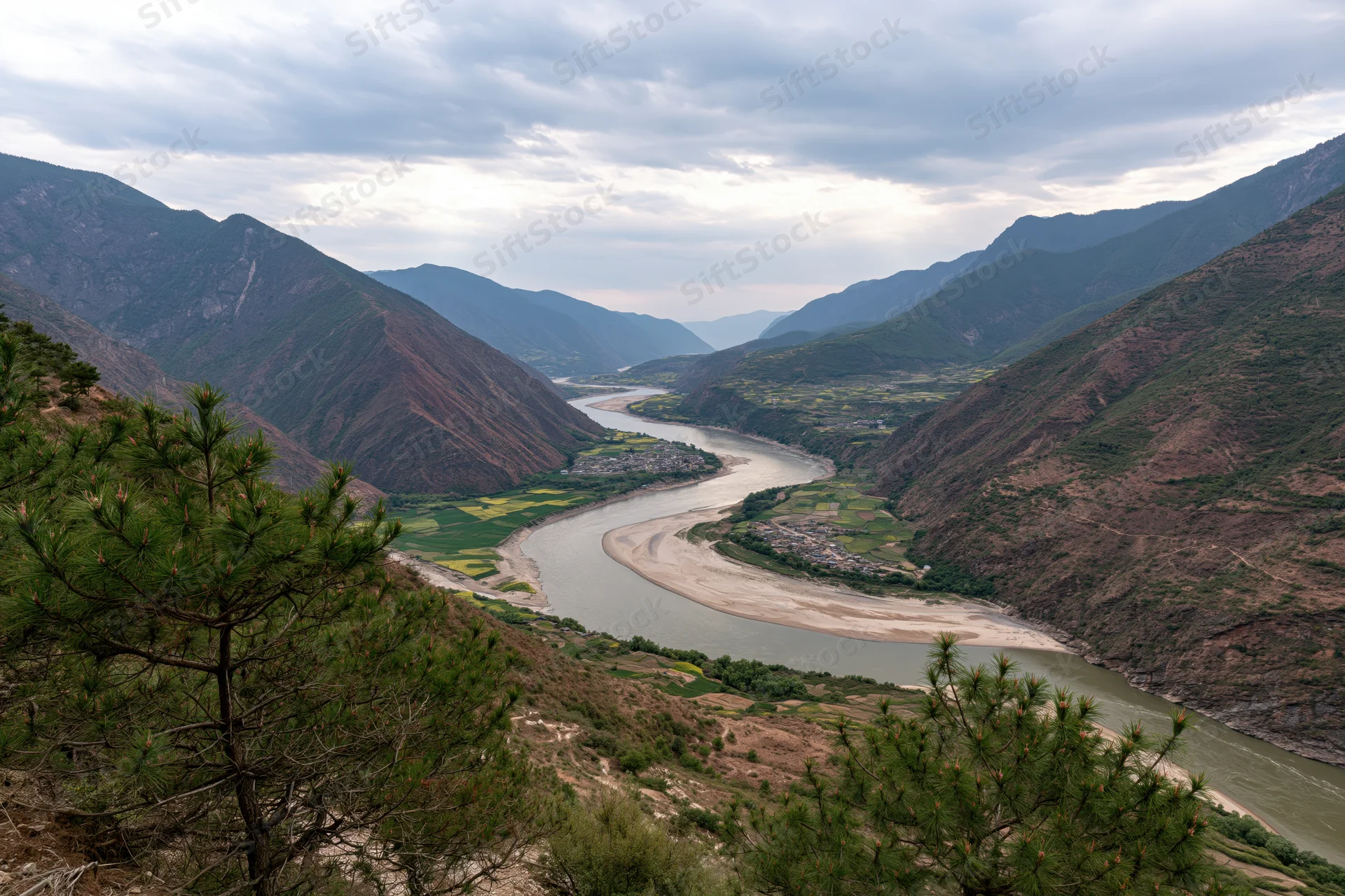 Wide aerial view of the yangtze river bending through a mountain valley in yunnan china