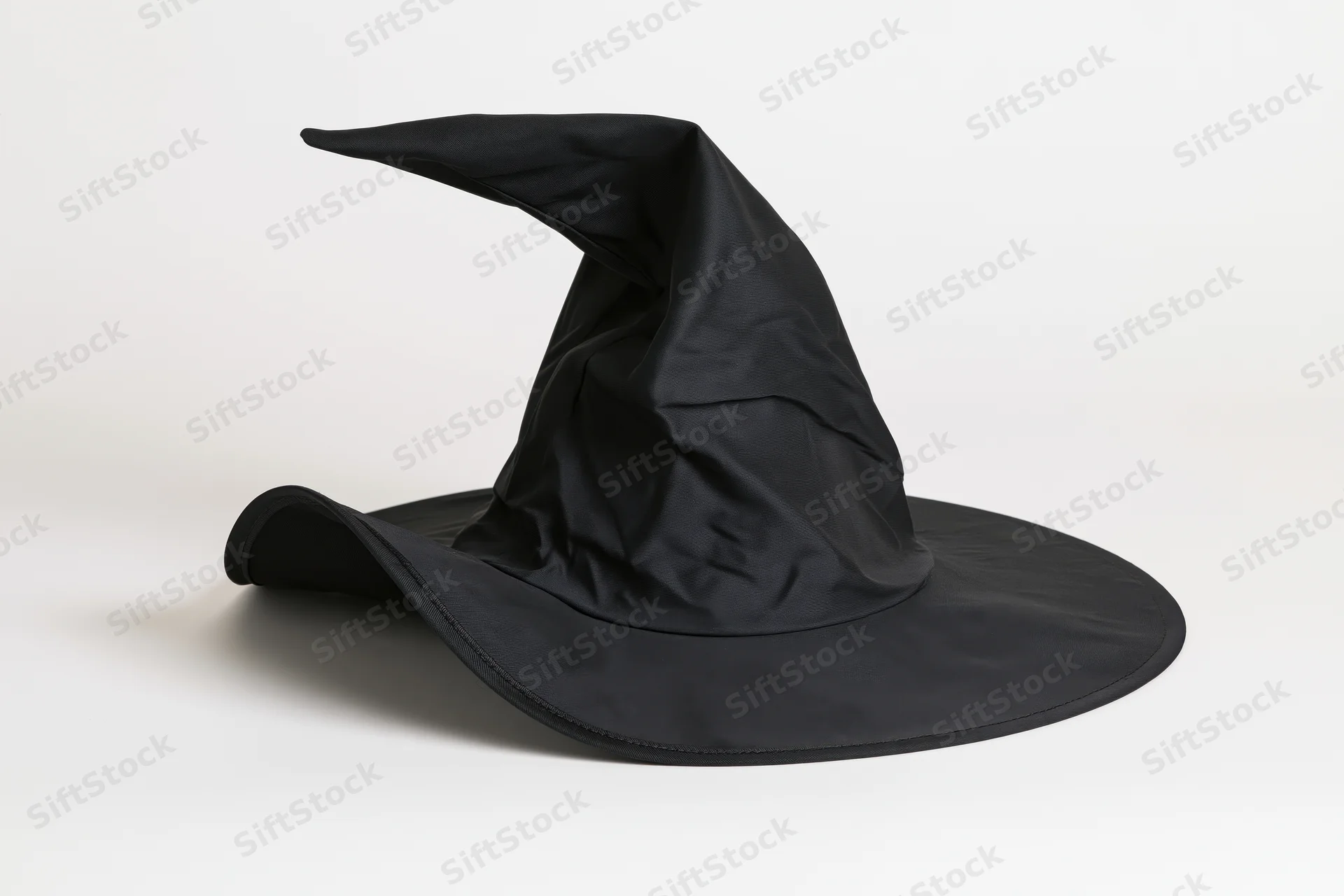 Black pointed witch hat with wide bent brim on white background