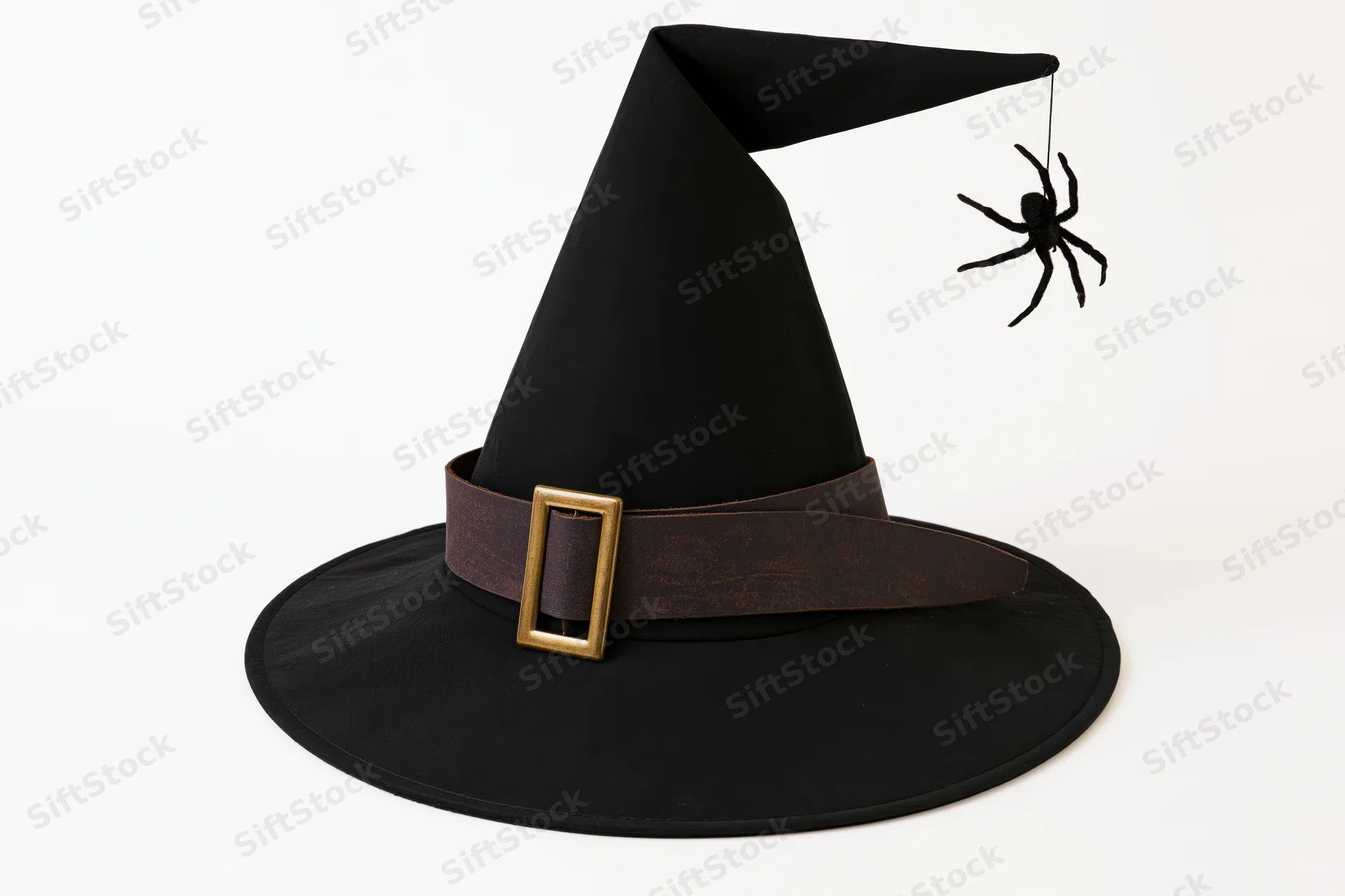 Black witch hat with wide brim and gold buckle, spider hanging from tip, on white background