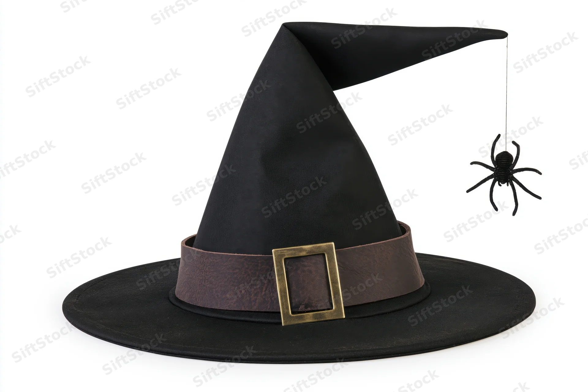 Black witch hat with wide brim and brown leather band featuring gold buckle, spider hanging from tip, isolated on white