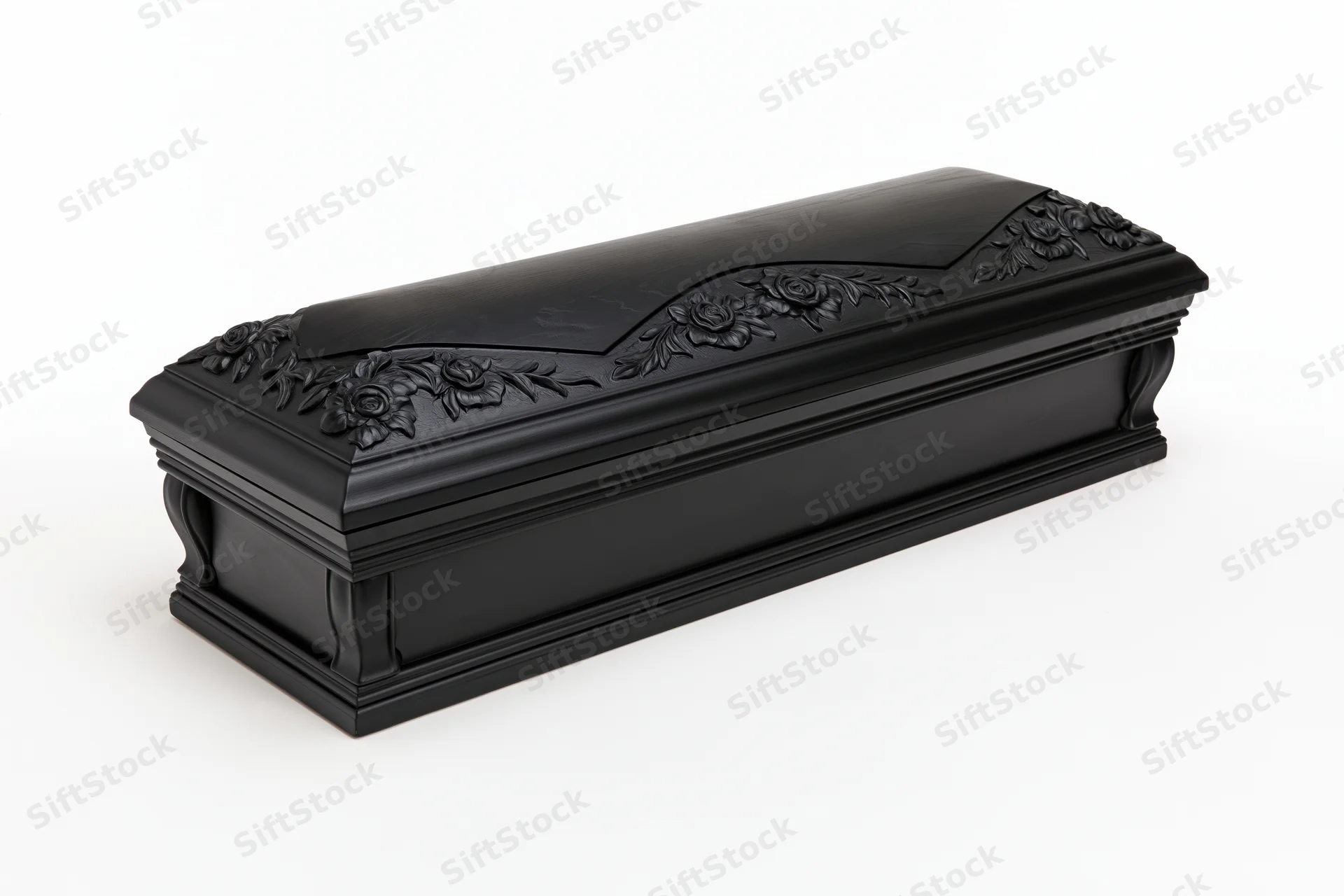 Closed black lacquered wooden coffin with carved floral relief on white background