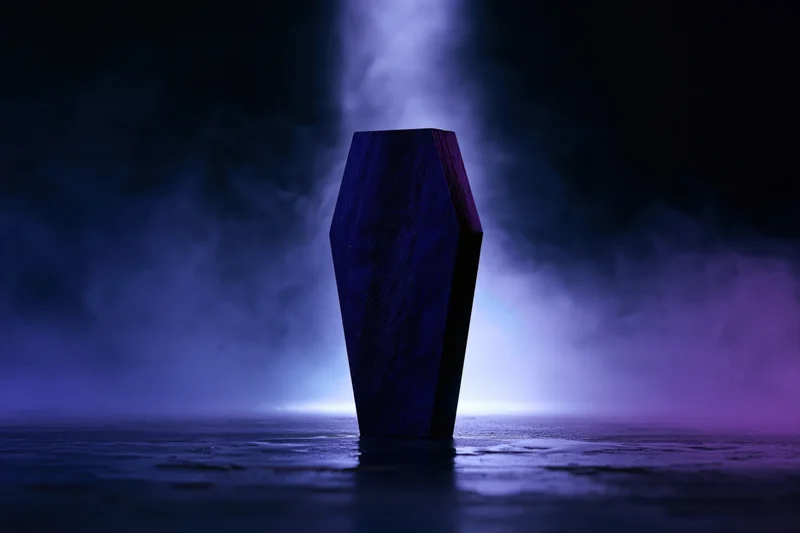 Dark wooden miniature coffin standing upright on wet reflective surface in smoky purple-lit night