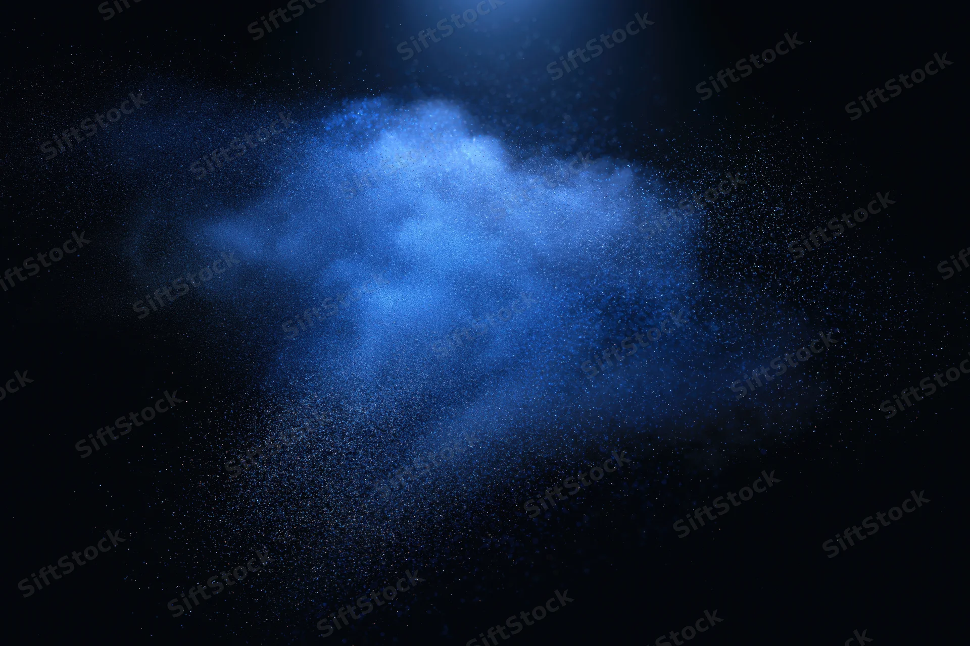 Blue powder cloud suspended in dark space with glowing particles and motion blur