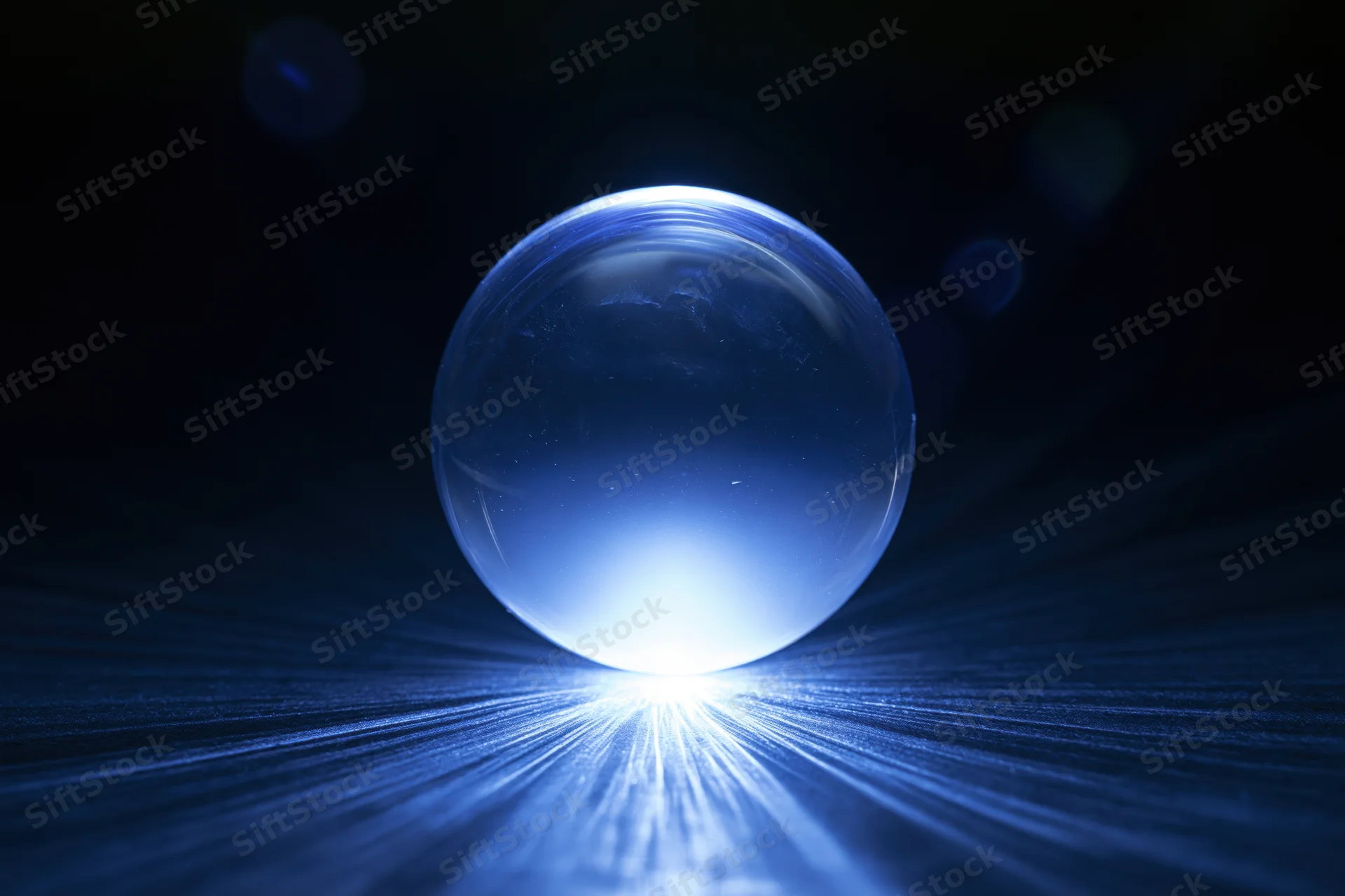 Glowing crystal ball resting on dark reflective surface with light beams radiating outward