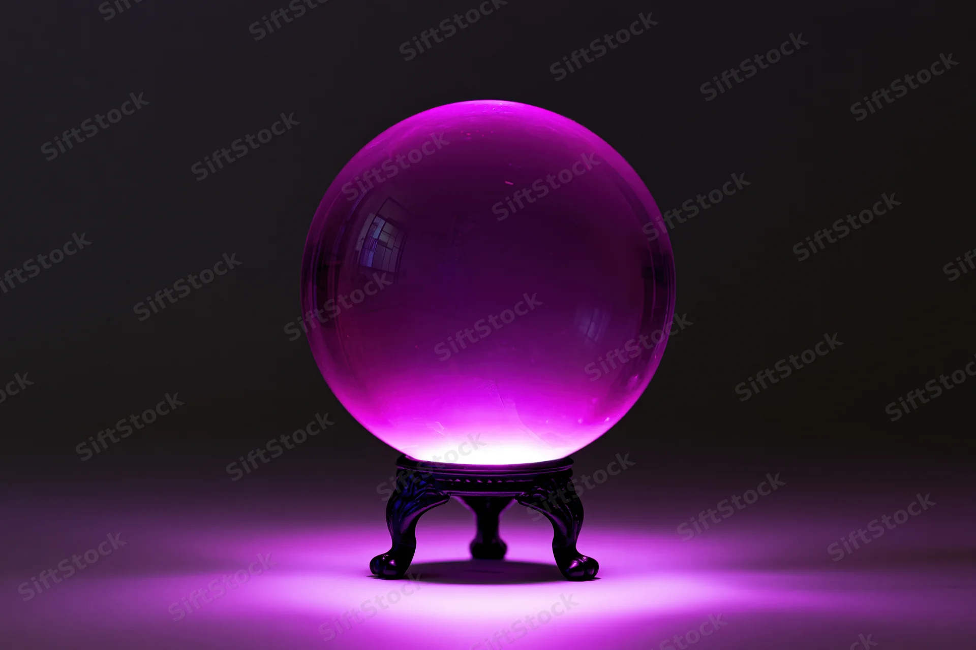 Glowing magenta crystal ball on ornate stand in dark studio setting