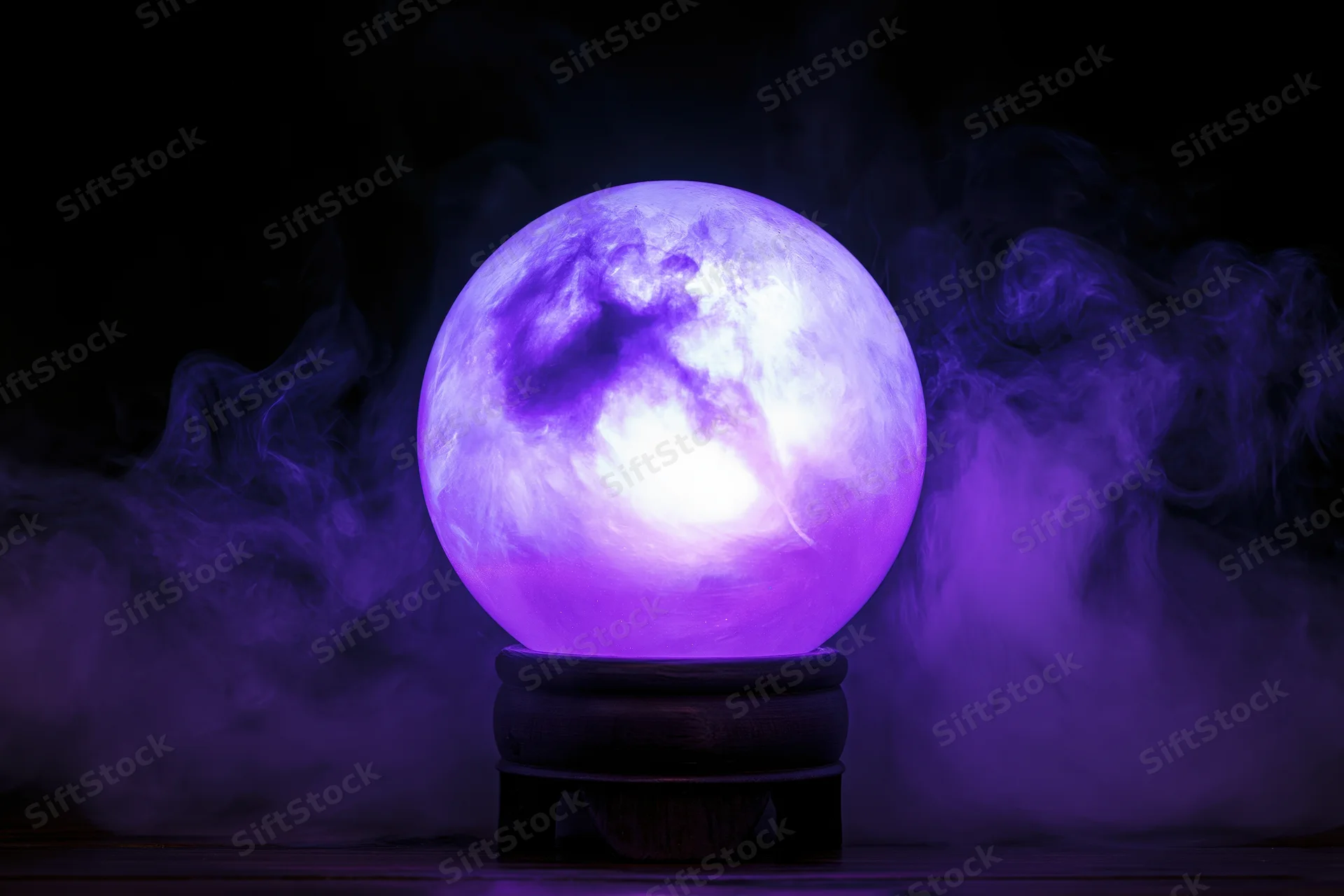 Glowing purple crystal ball on wooden base surrounded by smoke