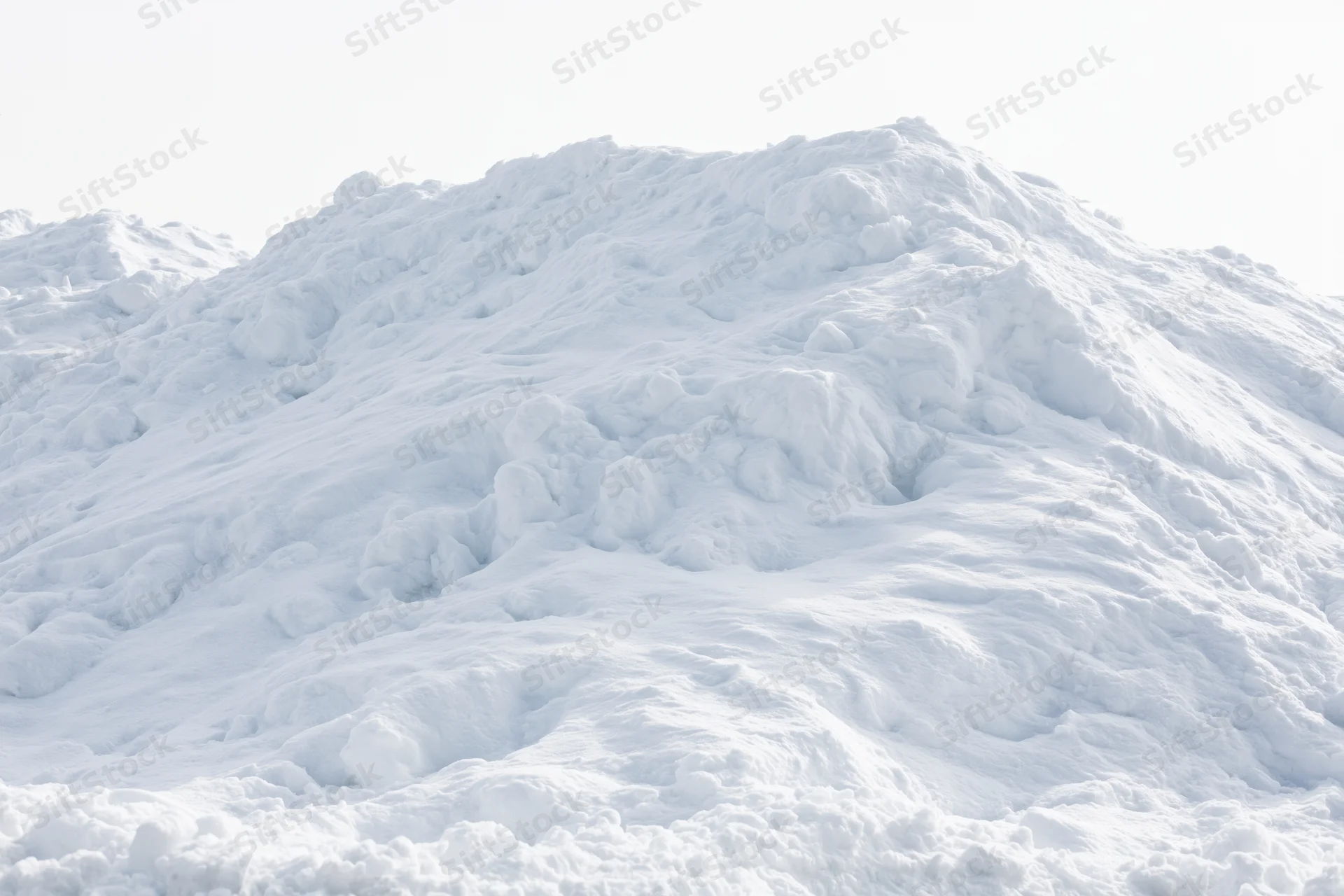 Large mound of plowed snow piled high outdoors