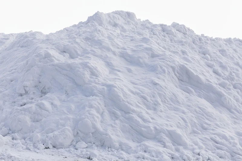 Large mound of plowed snow piled high outdoors