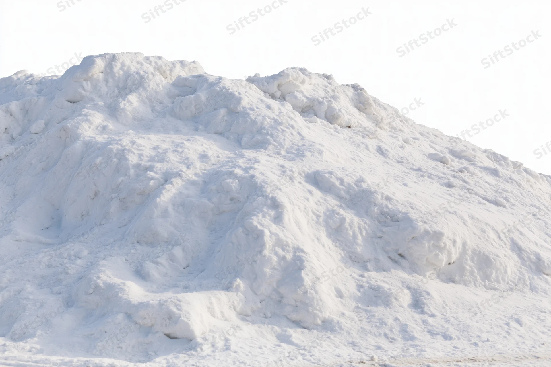 Large mound of plowed snow piled high outdoors
