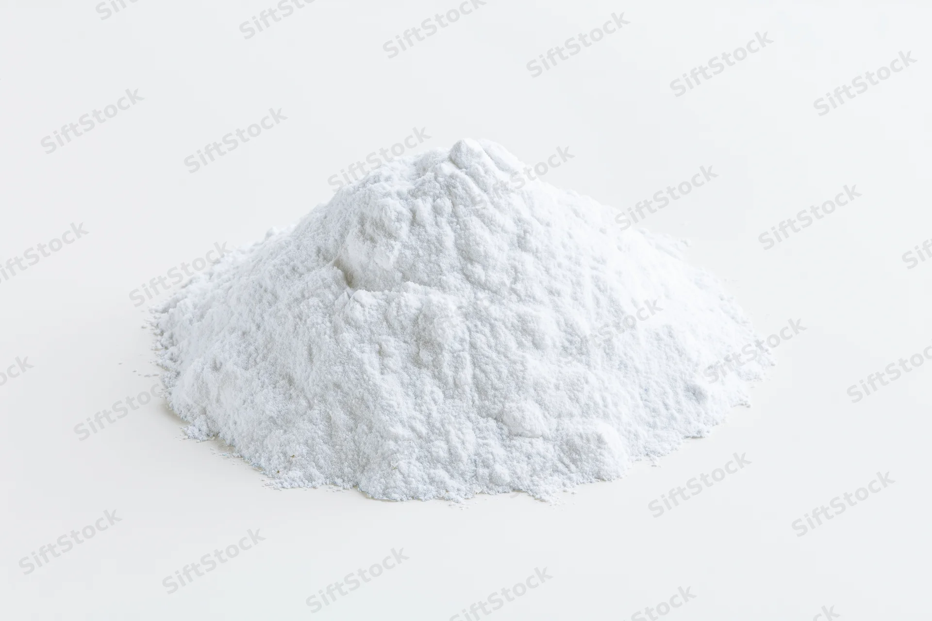 Mound of white powder on plain white surface