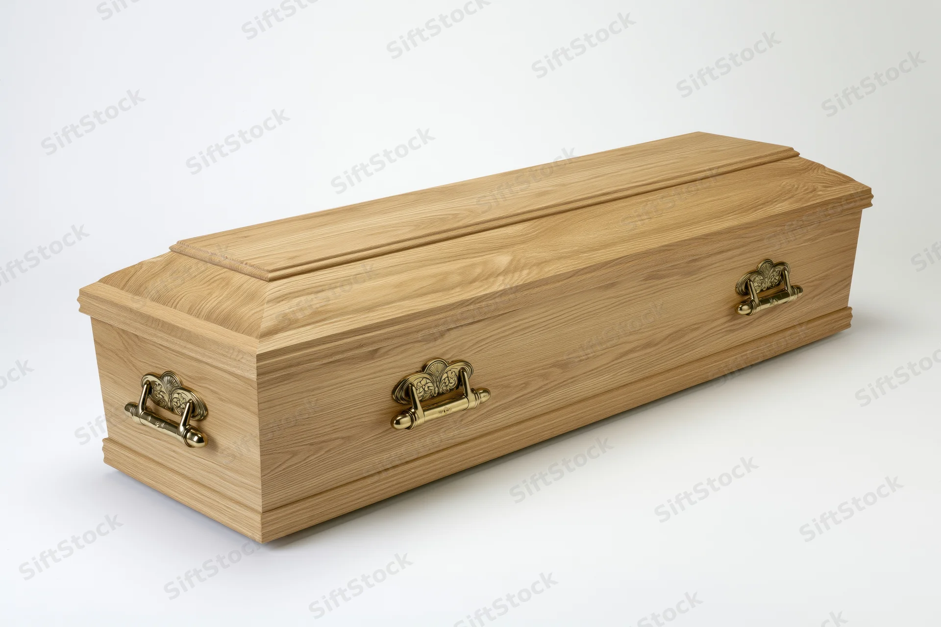 Wooden coffin with brass handles on white background