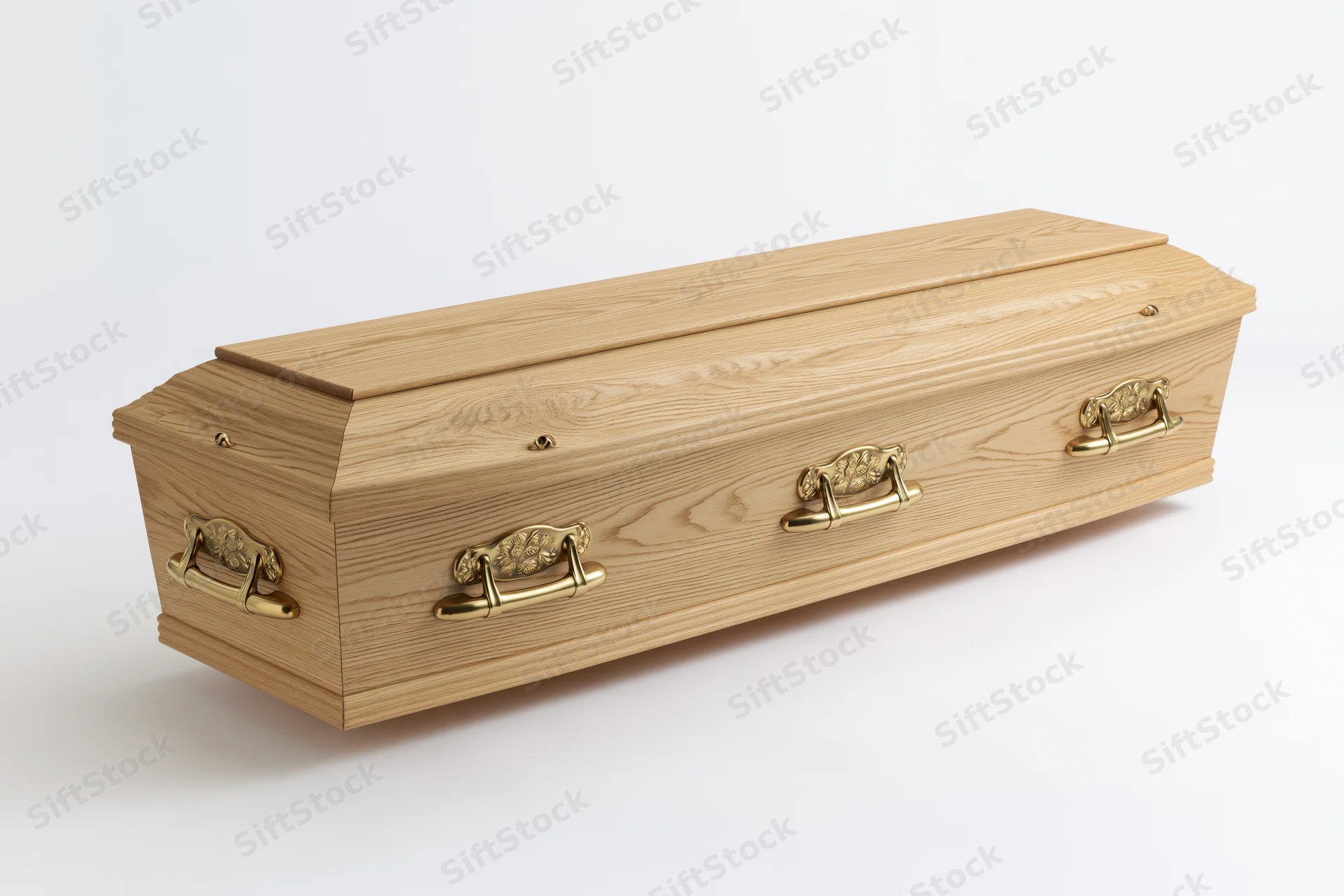 Wooden coffin with brass handles on white background