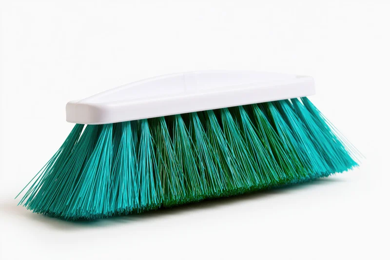 Plastic broom head with teal and green synthetic bristles on white background